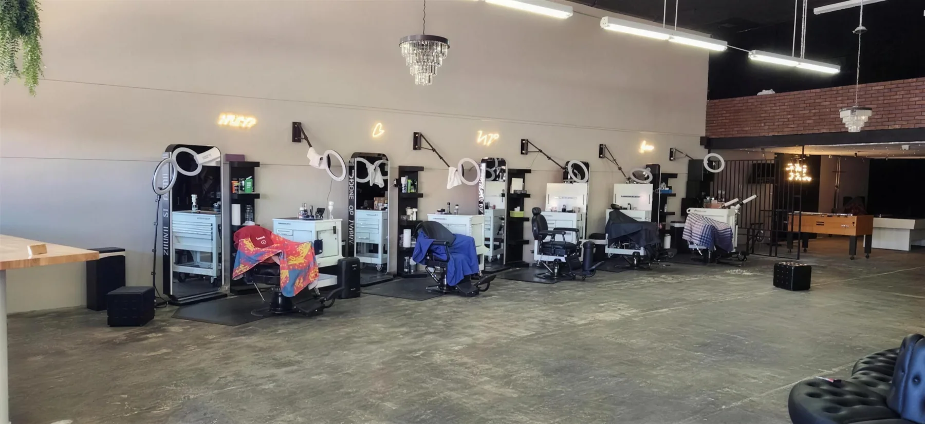 Barber stations lit by ring lights at House of Fadez